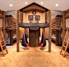 a room filled with bunk beds and ladders