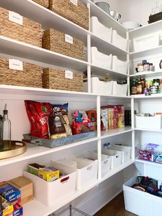 an organized pantry with white shelving and bins filled with food, including cereal