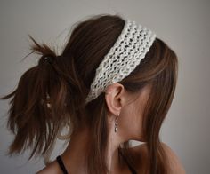 a woman with her hair in a ponytail wearing a crochet headband