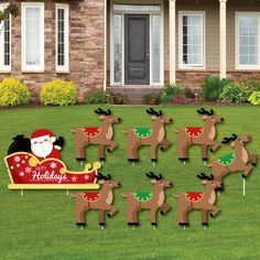 christmas reindeer yard decorations in front of a house with santa's sleigh