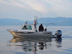 a man on a boat with a fishing rod