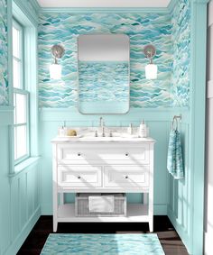 a bathroom with blue and white walls, wooden floors and a large mirror on the wall