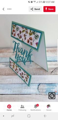 a handmade thank you card is displayed on a wooden table with the words thank you