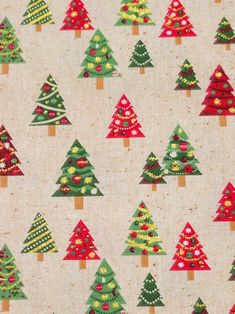 christmas trees on white fabric with red, green and yellow decorations