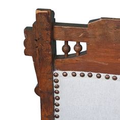 an old wooden bed frame with buttons and rivets on the side, against a white background