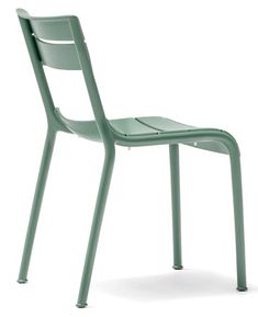 a green plastic chair sitting on top of a white floor