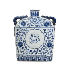 a blue and white vase with an arabic writing on the front, sitting against a white background