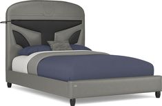 a bed with a gray headboard and blue sheets