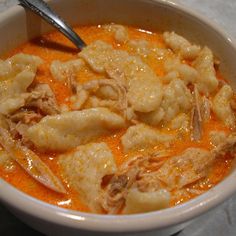 a white bowl filled with food on top of a table