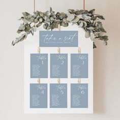 a seating chart with eucalyptus leaves on it