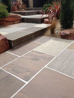 an outdoor patio with steps and plants