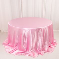 a round table covered in pink satin