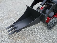 the front end of a skid steer on gravel