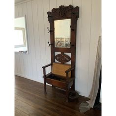 an old wooden bench with a mirror on it's back and a chair in front of it