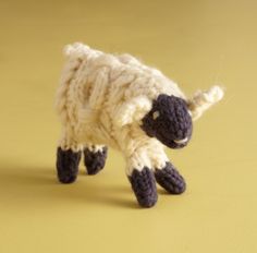 a small stuffed sheep on a yellow background