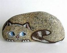 a rock with a cat painted on it