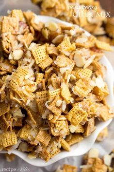 a white bowl filled with chex mix