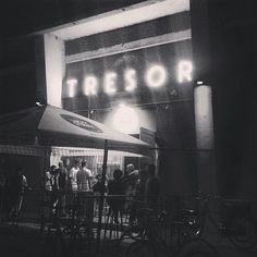 a group of people standing in front of a building with the word tressor on it