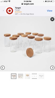 a group of glass jars with wooden lids on the top and bottom, all in different sizes