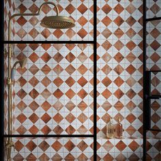 an orange and white tiled shower in a bathroom