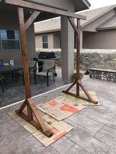 an outdoor patio area with various pieces of wood on the ground