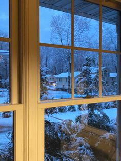 an open window with snow on the ground outside