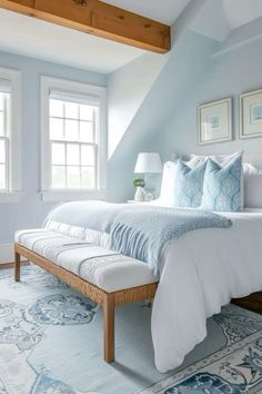 a bedroom with blue walls and white bedding