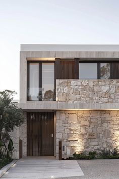 an exterior view of a modern house with stone walls and doors on the outside wall