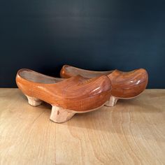 two wooden shoes sitting on top of a wooden table