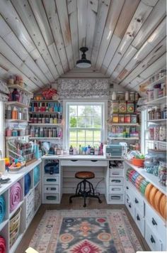 a room filled with lots of crafting supplies on shelves next to a large window