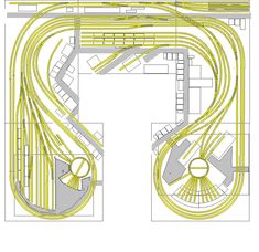 an overhead view of a train track with yellow lines on the ground and two different tracks in