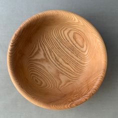 a wooden bowl sitting on top of a table