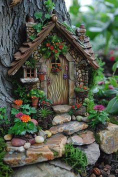 a small house made out of rocks and stones next to a tree with potted plants