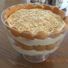 a cake in a glass dish on a wooden table