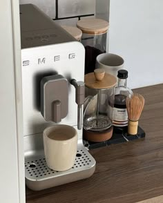 an espresso machine sitting on top of a wooden table