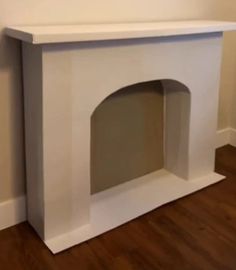 a dog house built into the side of a wall in a room with hardwood floors