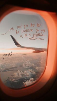 an airplane window with writing on it and the view out the plane's window