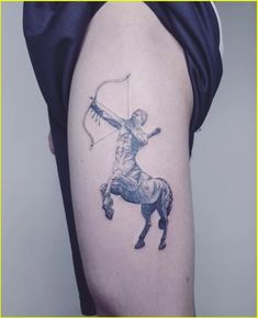 a man with a bow and arrow on his arm