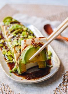 a plate with some food on it and chopsticks sticking out of the top