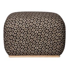 a black and white ottoman with an intricate pattern