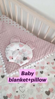 a baby crib bedding set with pink and grey hearts on it, in the shape of a mouse