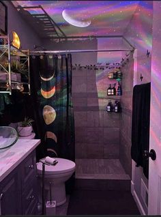 a bathroom with a toilet, sink and shower curtain in it's center area