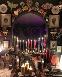 a table topped with lots of candles and pictures