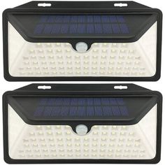 two solar powered motion sensor lights with white leds on each side and black back