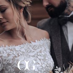 a woman in a wedding dress standing next to a man