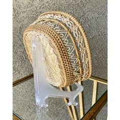 three wicker chairs sitting on top of a glass table