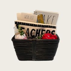 a black basket filled with books and other items