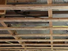 the inside of a building with wooden beams