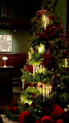 a christmas tree decorated with candles and ornaments