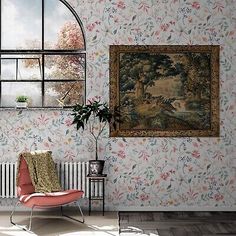 a room with a chair, rug and painting on the wall next to a window